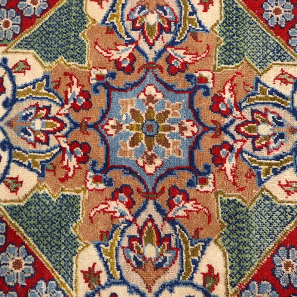 Ornate oriental rug with blue, red, and beige floral patterns and a central medallion