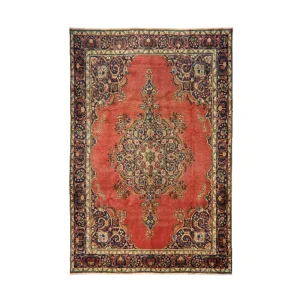 Red Persian-style rug with a central floral medallion and ornate navy border.
