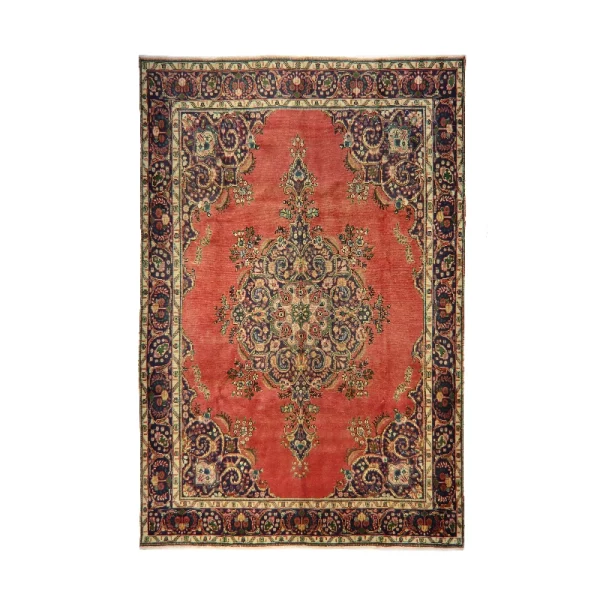 Red Persian-style rug with a central floral medallion and ornate navy border.