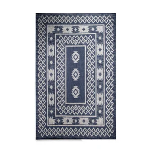 Blue woven rug with a double geometric border in white and a central diamond motif areaing a lighter blue field workwear-like texture.
