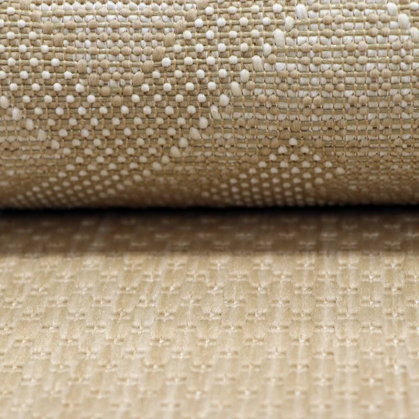 Close-up of a beige and white woven fabric with small tufted yarns.